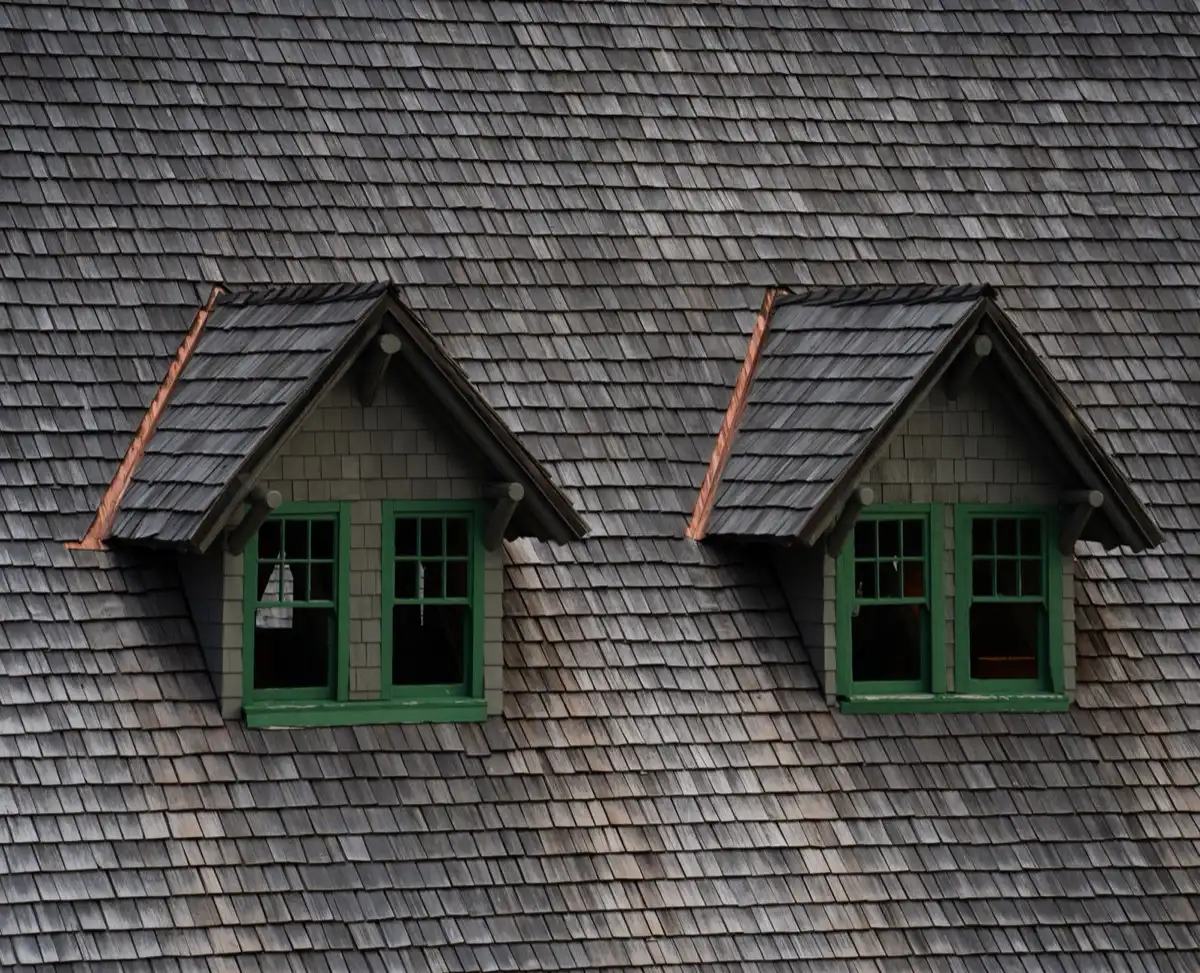 Dormers on a shingle roof in Norman, OK, where step flashing and kickout flashing carry water past the walls
