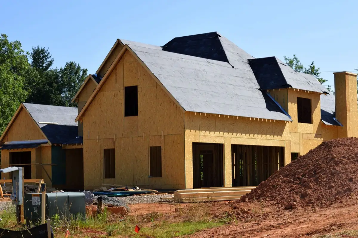 House with new roof decking and synthetic underlayment during a roof replacement in Norman, OK